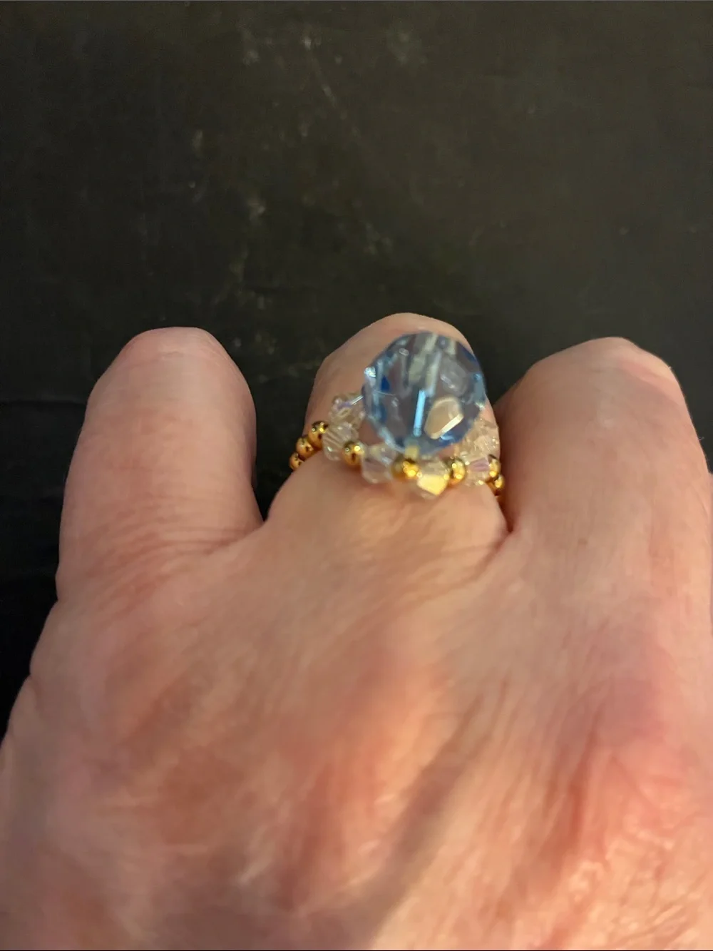 Gold-Tone Stretch Beads.Ring with Light Blue Faceted Stone and Crystal Accents.